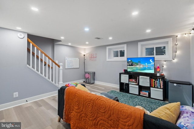 living room featuring recessed lighting, visible vents, stairway, and baseboards