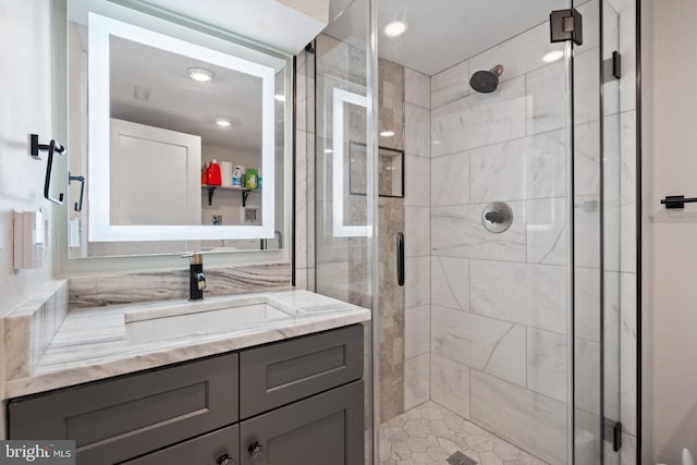 bathroom featuring a shower stall and vanity