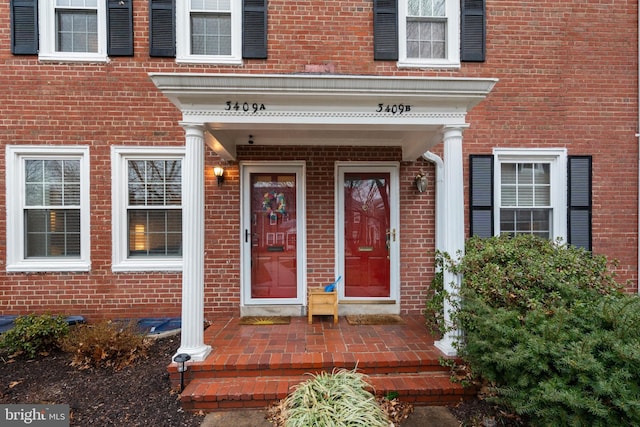 view of exterior entry with brick siding