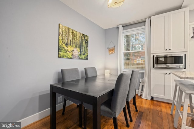 dining room featuring light wood-style flooring and baseboards