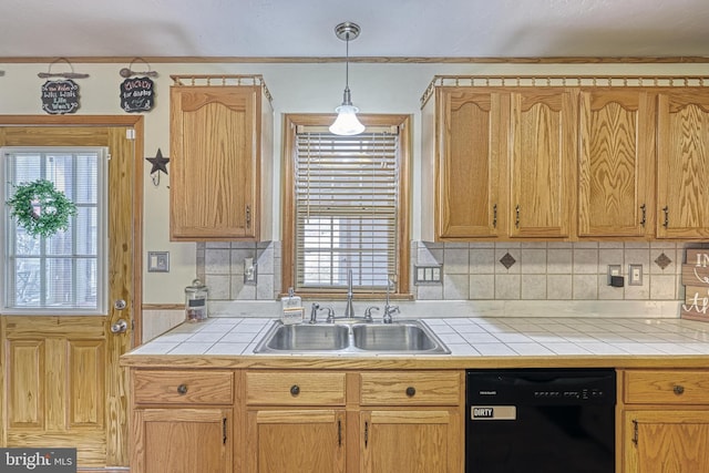 kitchen with dishwasher, tile countertops, plenty of natural light, and a sink