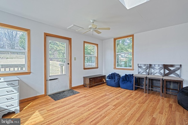 interior space with light wood finished floors, ceiling fan, and baseboards