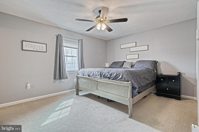 carpeted bedroom with a ceiling fan, baseboards, and a textured ceiling