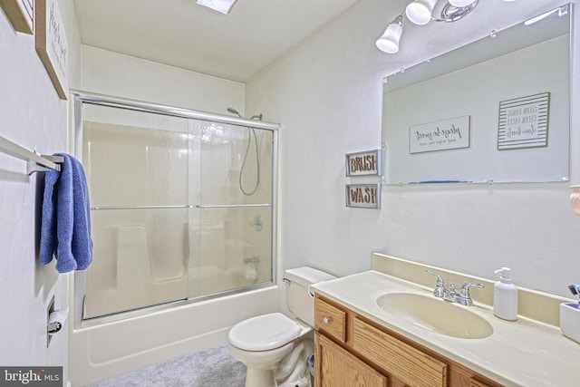 full bathroom with toilet, shower / bath combination with glass door, and vanity