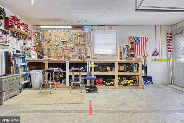 interior space featuring concrete block wall and a workshop area