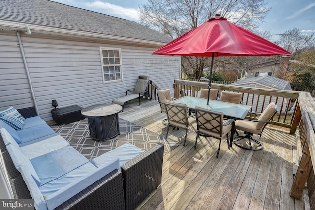 wooden terrace with outdoor dining space and an outdoor hangout area