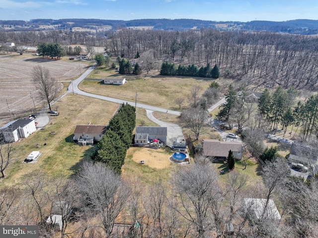 birds eye view of property with a rural view and a view of trees