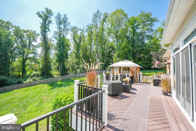 wooden deck featuring a lawn and fence