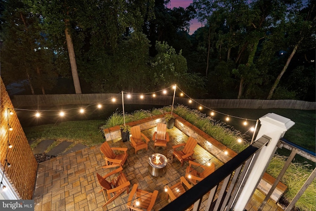 view of patio featuring an outdoor fire pit and fence