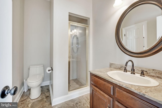 bathroom with toilet, a stall shower, baseboards, and vanity