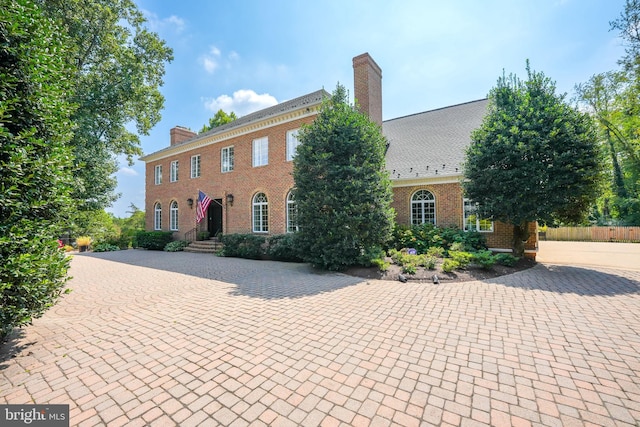 colonial house with brick siding and a chimney