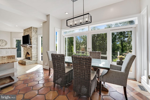 dining area featuring a fireplace, visible vents, a notable chandelier, and recessed lighting