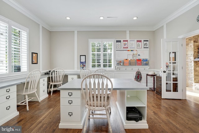 kitchen featuring crown molding, built in desk, dark wood finished floors, and white cabinets