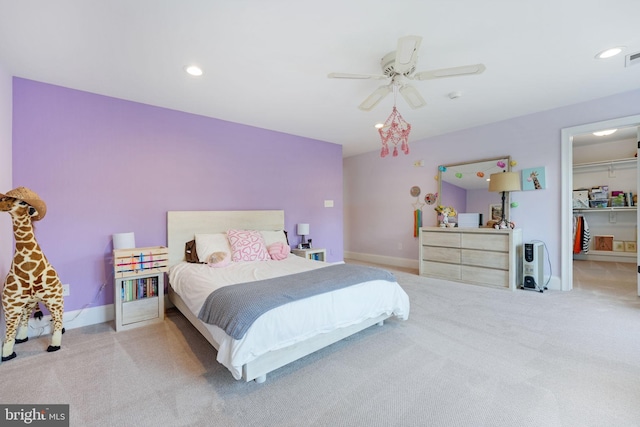 carpeted bedroom featuring ceiling fan, a spacious closet, baseboards, and recessed lighting