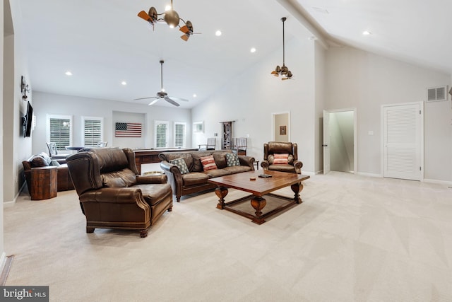 living area with light carpet, visible vents, baseboards, ceiling fan, and high vaulted ceiling