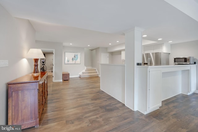 interior space with dark wood-type flooring, recessed lighting, stairway, and baseboards