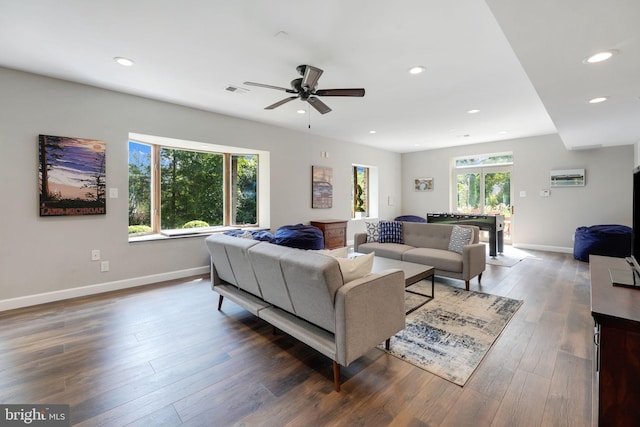 living area featuring recessed lighting, baseboards, and wood finished floors