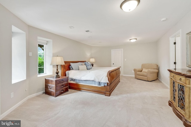 bedroom with light carpet, visible vents, and baseboards