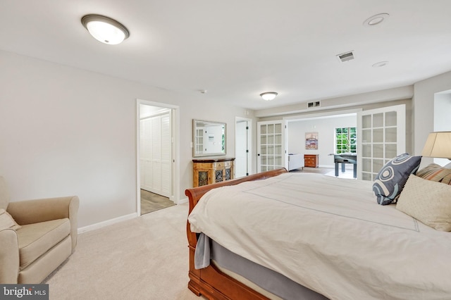 bedroom with french doors, light carpet, visible vents, and baseboards