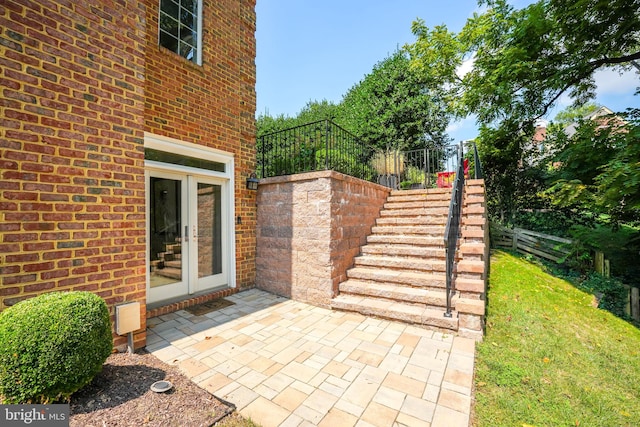 view of patio with stairs, french doors, and fence