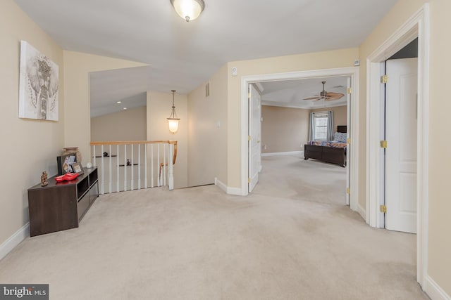 corridor with carpet, visible vents, baseboards, and an upstairs landing