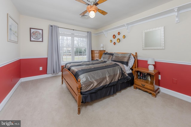 bedroom with ceiling fan, carpet floors, visible vents, and baseboards