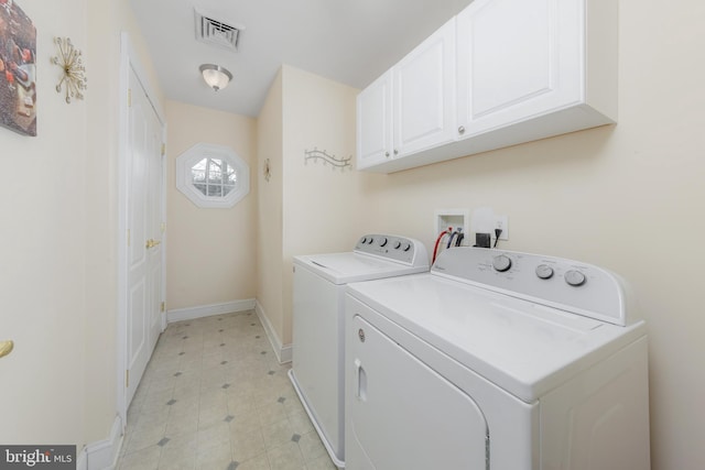 laundry area featuring cabinet space, baseboards, visible vents, light floors, and separate washer and dryer