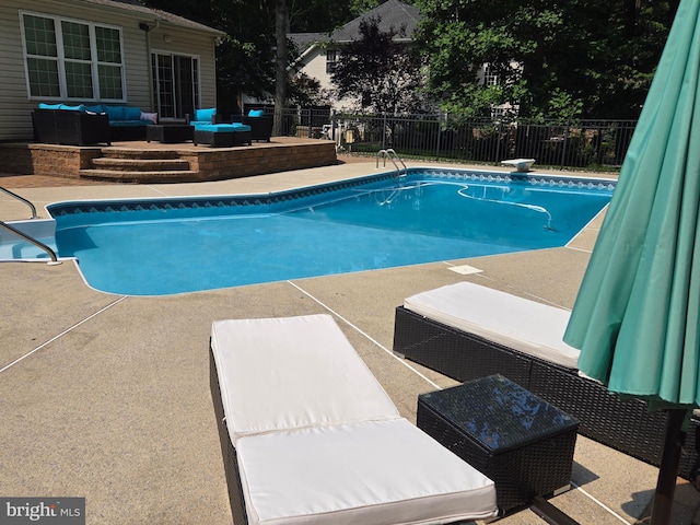 view of swimming pool featuring a fenced in pool, a patio area, outdoor lounge area, and fence