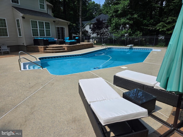 view of swimming pool with a fenced in pool, a patio area, fence, and an outdoor hangout area