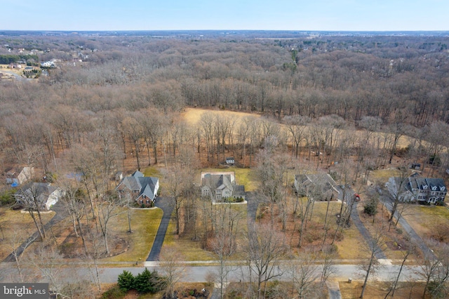 birds eye view of property with a view of trees