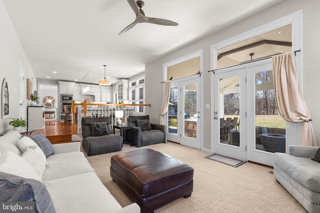 living room featuring recessed lighting, light carpet, and a ceiling fan