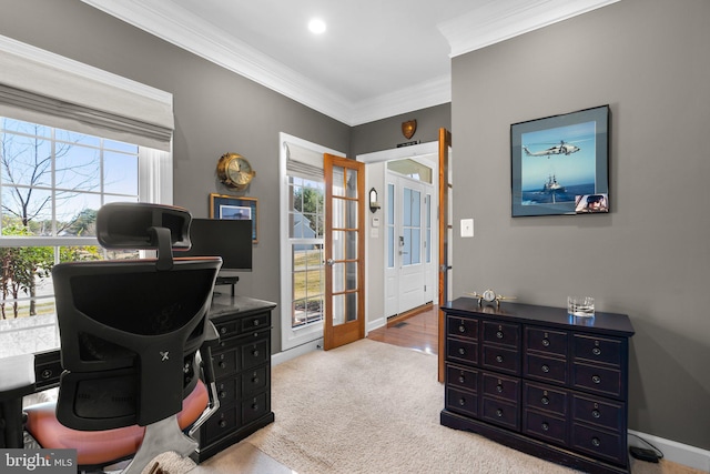 home office featuring baseboards, plenty of natural light, light carpet, and ornamental molding