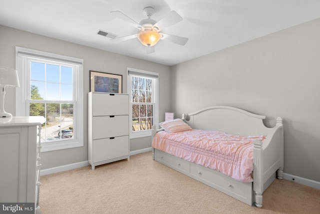 bedroom with ceiling fan, light colored carpet, visible vents, and baseboards