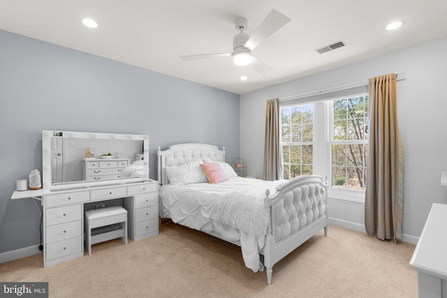 bedroom featuring light carpet, visible vents, and baseboards