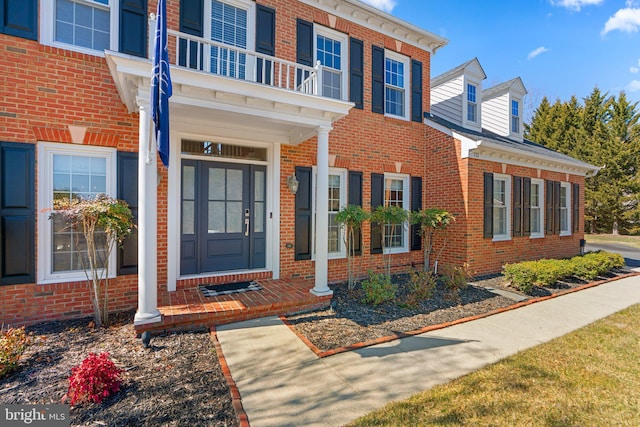 entrance to property featuring brick siding