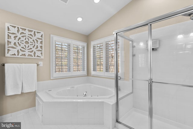 bathroom featuring tile patterned floors, a shower stall, a jetted tub, and vaulted ceiling