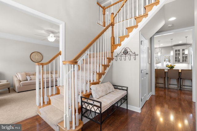 stairway with hardwood / wood-style flooring, recessed lighting, crown molding, baseboards, and ceiling fan