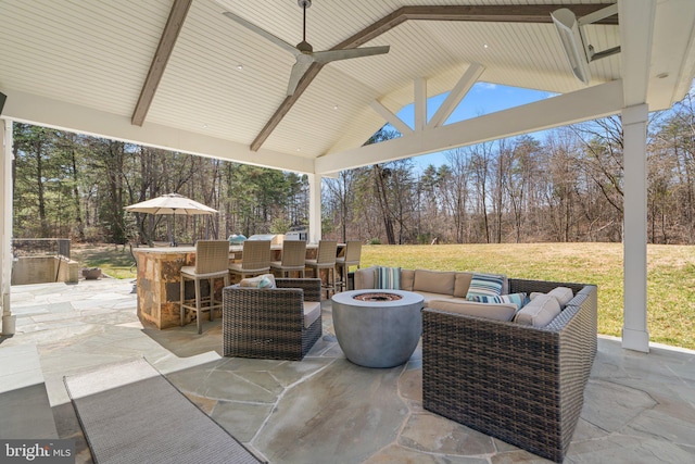 view of patio / terrace with outdoor dry bar, an outdoor fire pit, and ceiling fan