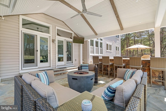 view of patio / terrace with an outdoor living space with a fire pit, outdoor dry bar, and ceiling fan