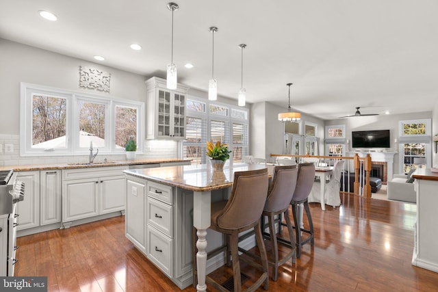 kitchen featuring white cabinetry, hardwood / wood-style flooring, and backsplash