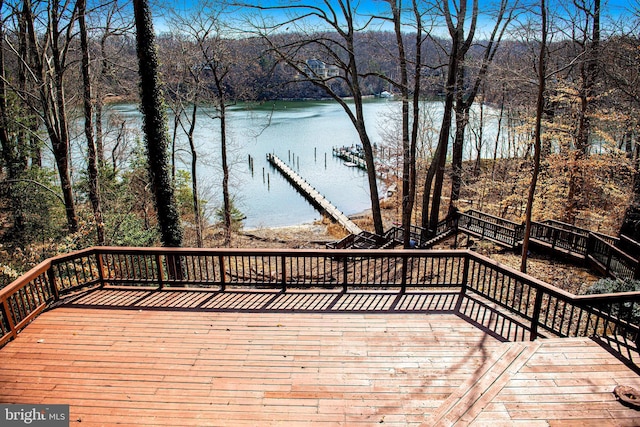 wooden terrace featuring stairway, a water view, and a dock