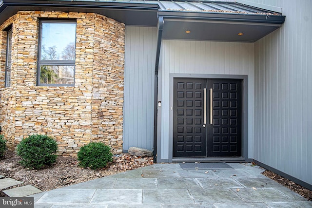 doorway to property with stone siding