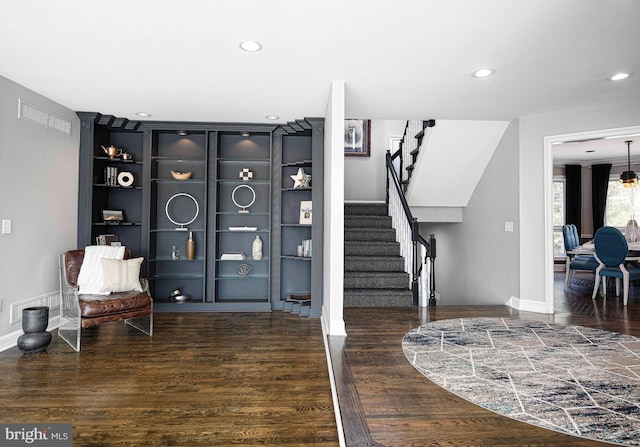 sitting room featuring stairway, recessed lighting, wood finished floors, and baseboards