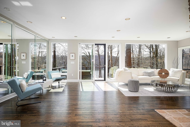 living area with recessed lighting and wood finished floors