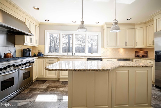 kitchen with a kitchen island, a sink, extractor fan, cream cabinetry, and appliances with stainless steel finishes