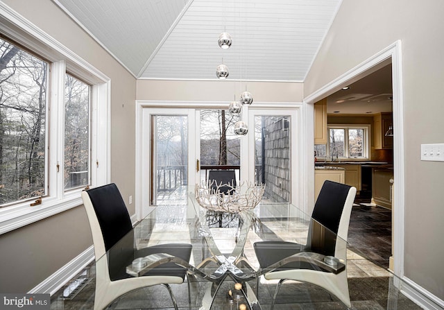 dining area with lofted ceiling and baseboards