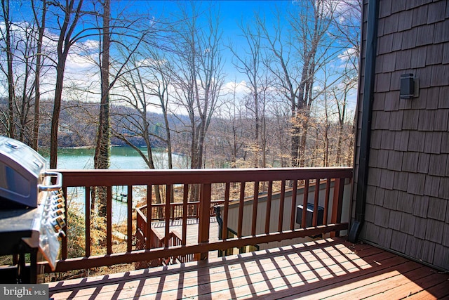 wooden deck featuring a water view