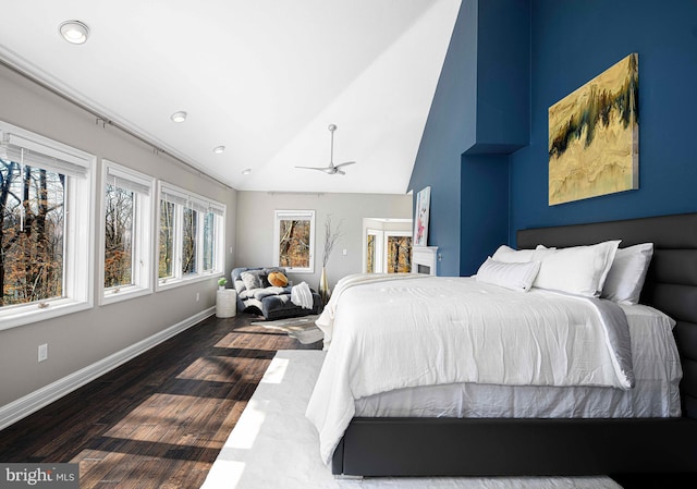 bedroom featuring baseboards, lofted ceiling, and dark wood-style flooring