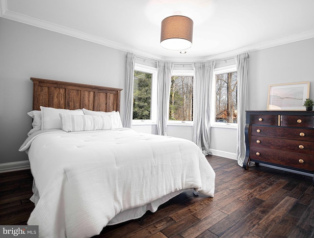 bedroom featuring baseboards, dark wood-style flooring, and crown molding