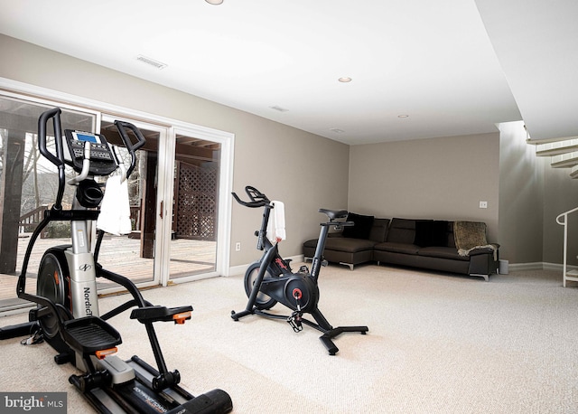 exercise room with visible vents, baseboards, and carpet